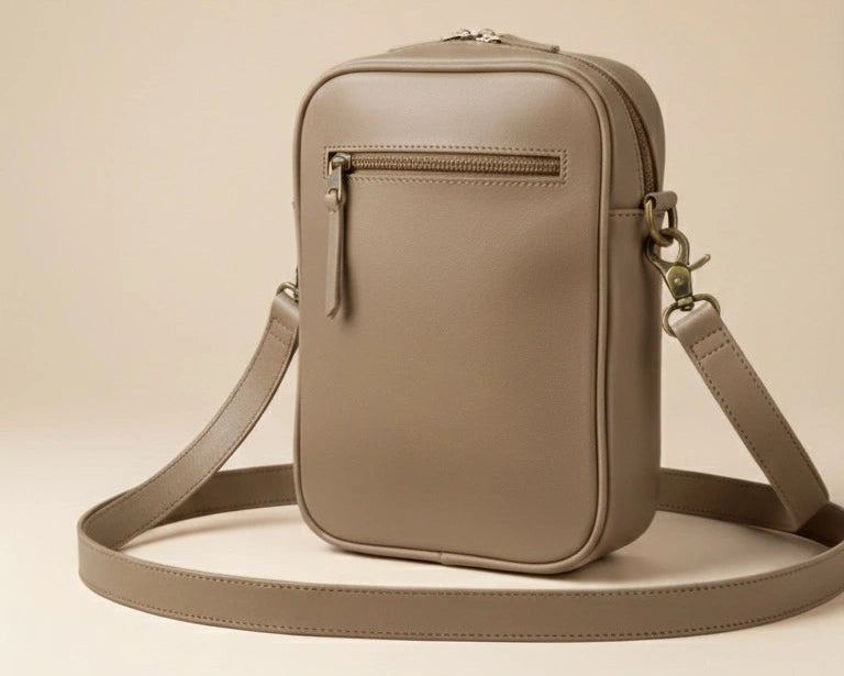 Beige crossbody bag on a beige background